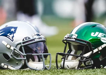 New England Patriot and NY Jets helmets set on the ground